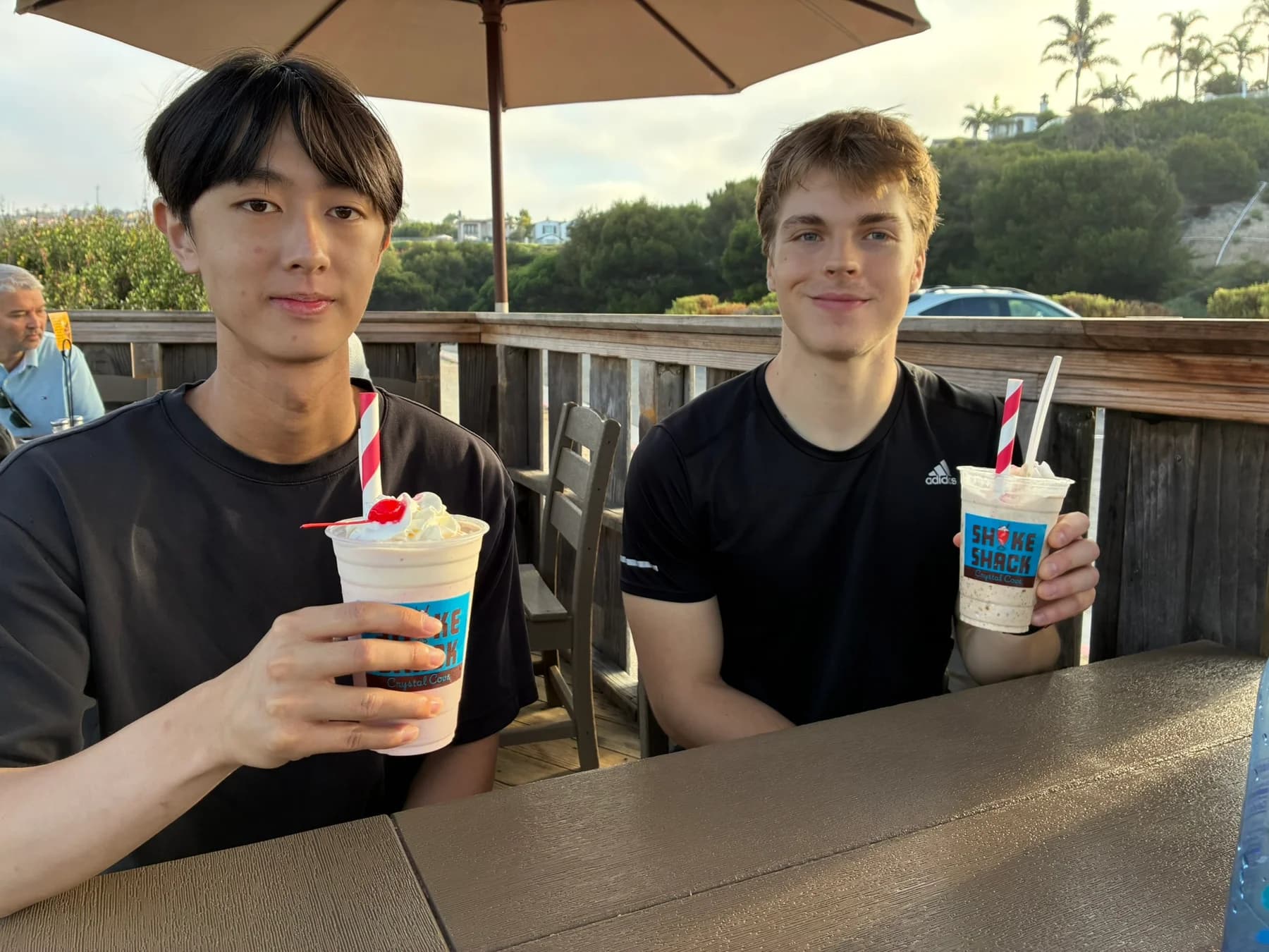 Enjoying milkshakes together at an outdoor café